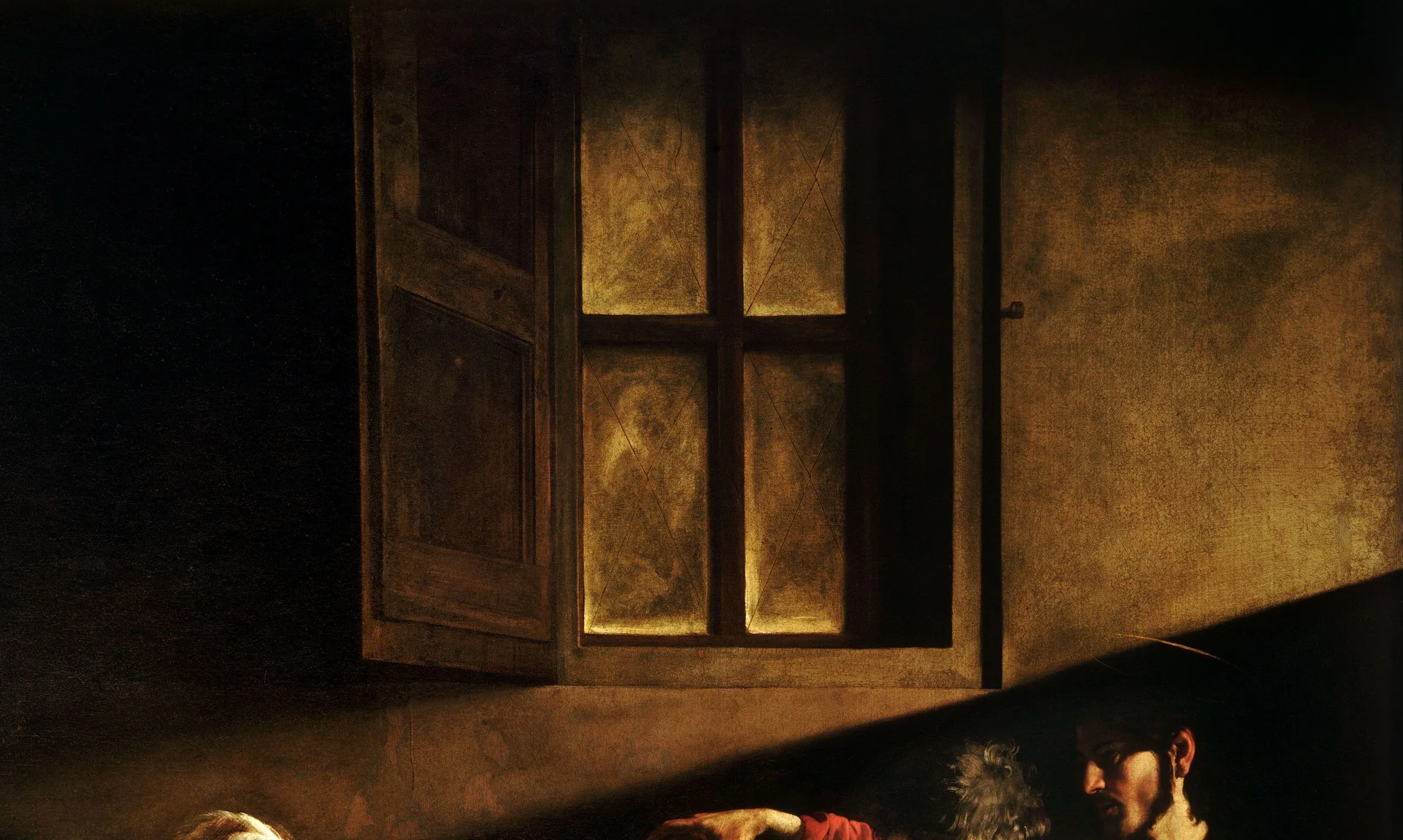 Detail of The Calling of Saint Matthew: the painted window is shuttered and throws nothing. The light comes from one high source outside the picture and lands as a hard wedge on the wall, and everything the wedge misses stays in the dark.