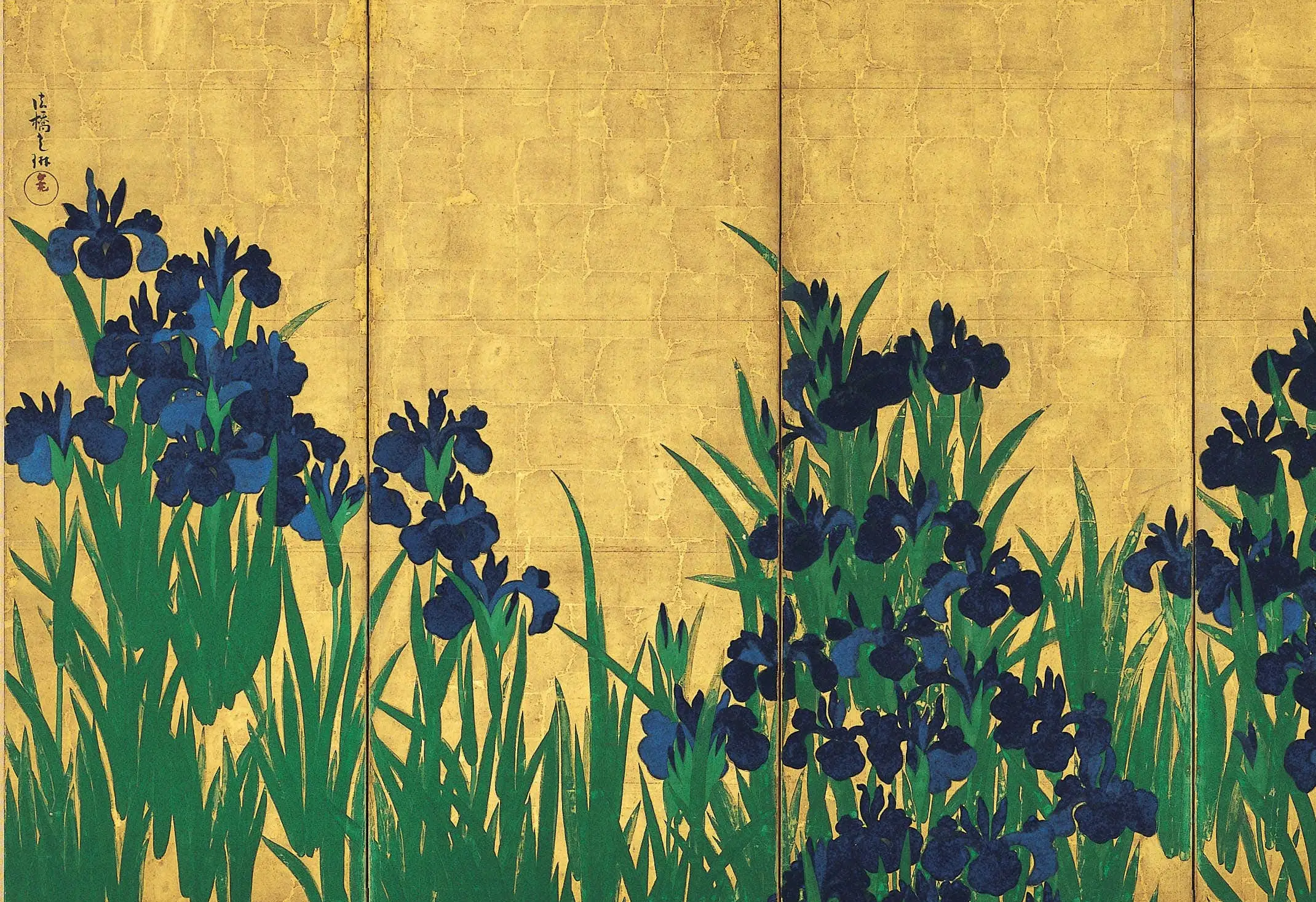 Detail of the Nezu Irises: the flowers are azurite, ground from blue copper ore, and the leaves are malachite, the green mineral that comes out of the same rock. The green carries visible brush direction while the blue is laid flat in two values, dark over light. Look along the row and several blooms repeat almost exactly, which is why a stencil is usually assumed.