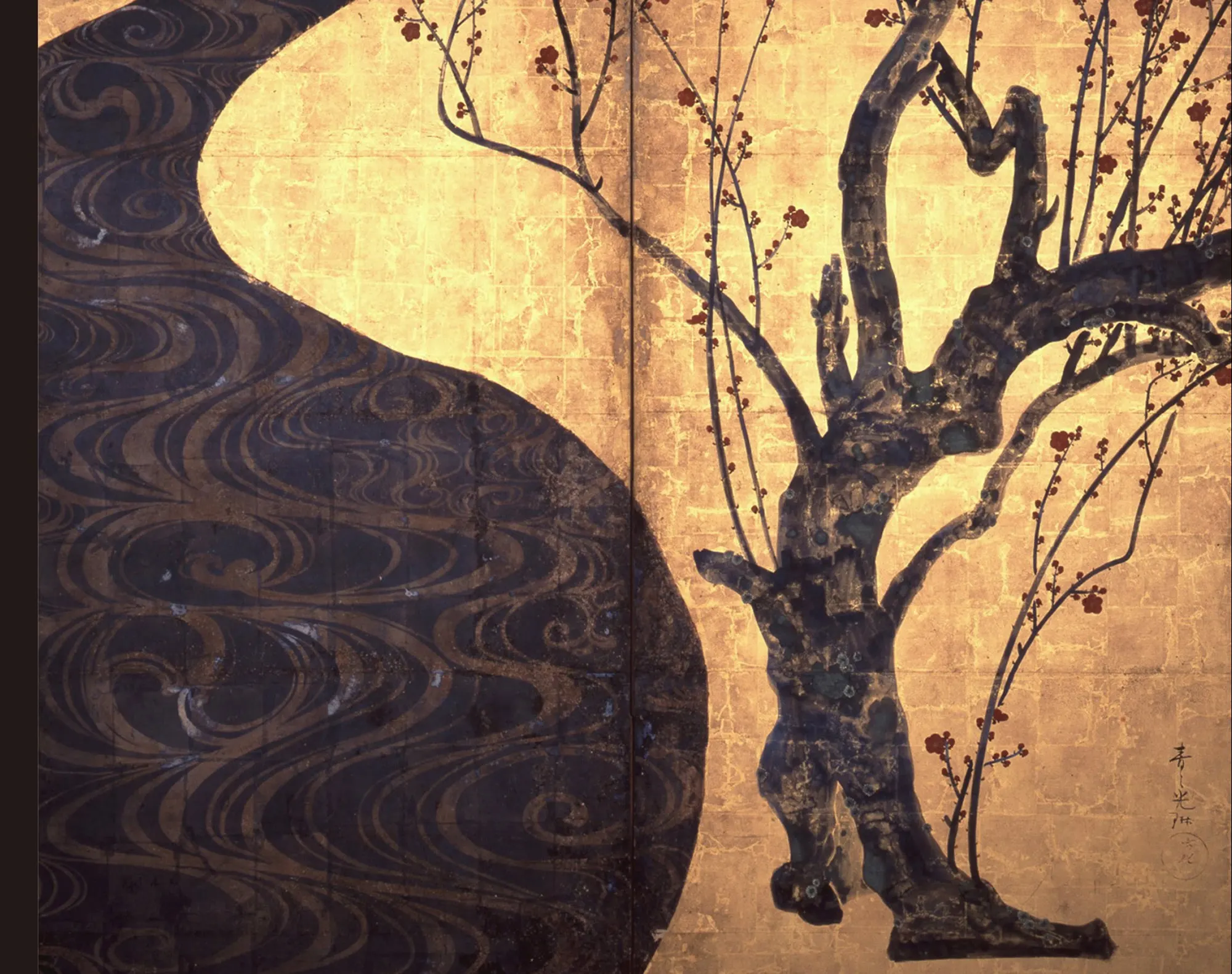 Detail of the red plum in Red and White Plum Blossoms: the trunk is one flat silhouette with no modelling inside it, and everything happening on its surface is pooled colour. Green was dropped into wet ink and pushed out to the edge of each patch as it dried, which is why the bark reads as moss and old lichen without one descriptive stroke. Behind it the gold is laid in squares and the seams can be counted.