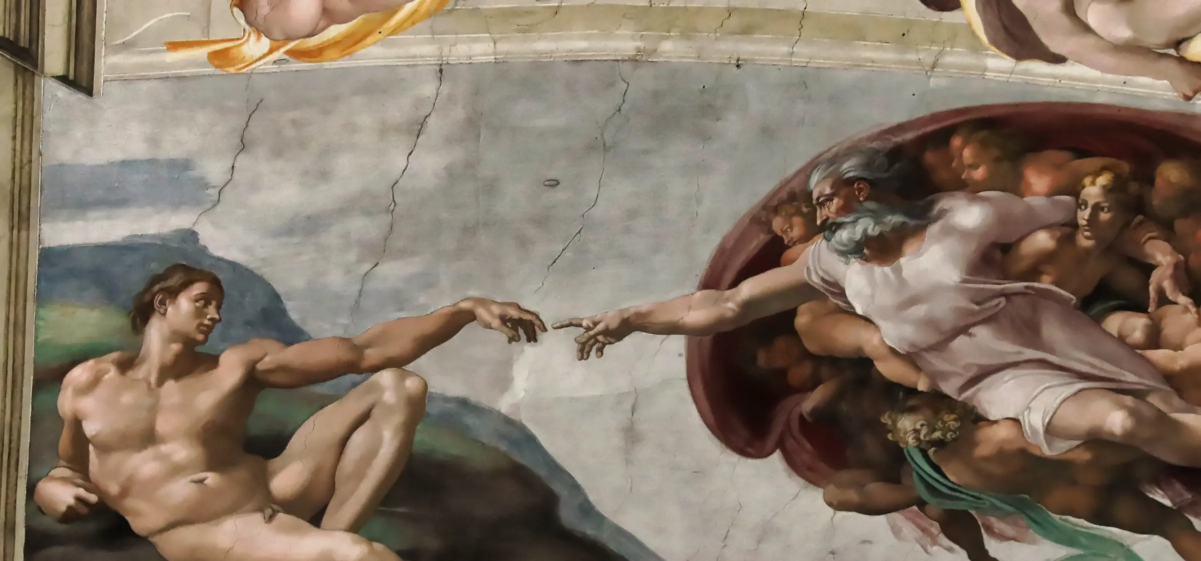 Detail of The Creation of Adam: the two hands do not touch, and the whole picture is built on that gap. The sky between them is not one surface either. The faint irregular joins crossing it are where one day's patch of wet plaster was butted against the next.