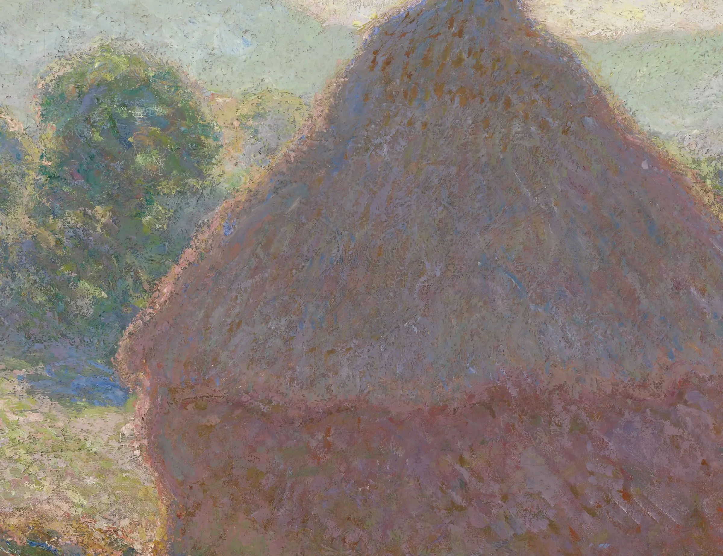 Detail of Meules, midday: the stack is not a brown shape with light on it. It is pink, blue, violet and ochre set down as separate touches that never mix on the palette, and the field beside it is the same mosaic carried out to the edge.