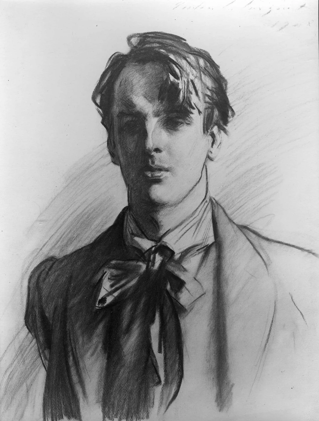 Charcoal portrait of William Butler Yeats: the darks pressed in with the side of the stick, the bare paper kept for the light, a head of the kind Sargent finished in one sitting.