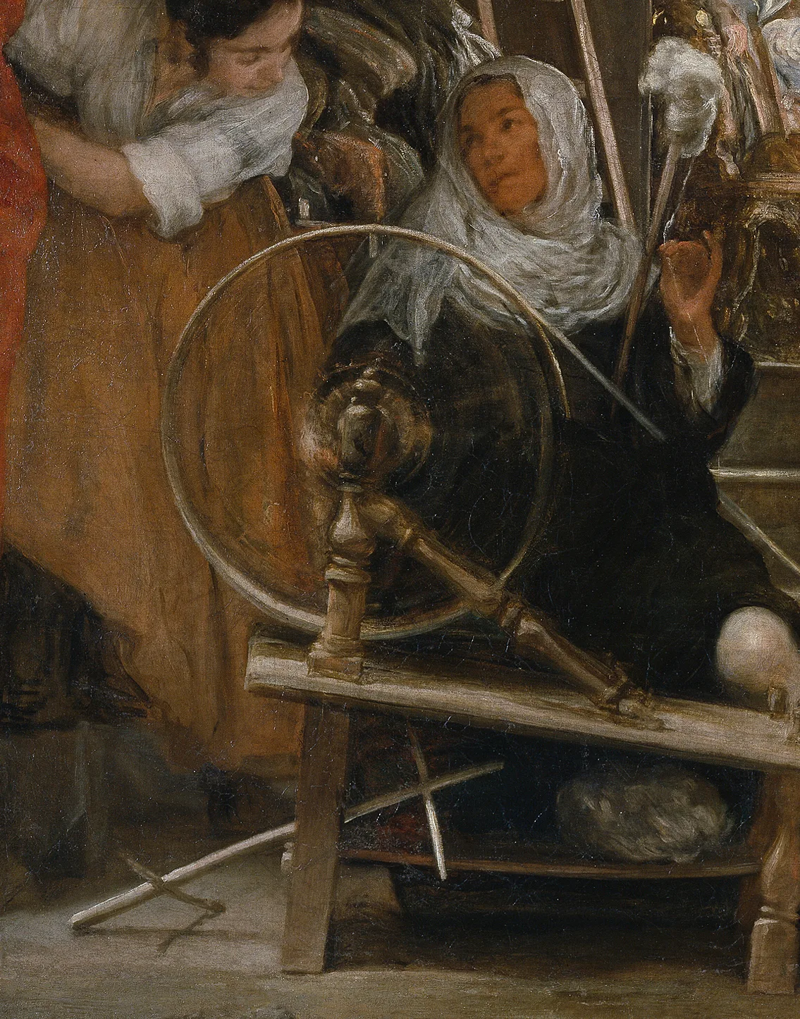 Detail of Las Hilanderas: the spokes of the spinning wheel dissolve into a blur of loose strokes, one of the first times a painter set down the motion itself instead of a wheel stopped still.