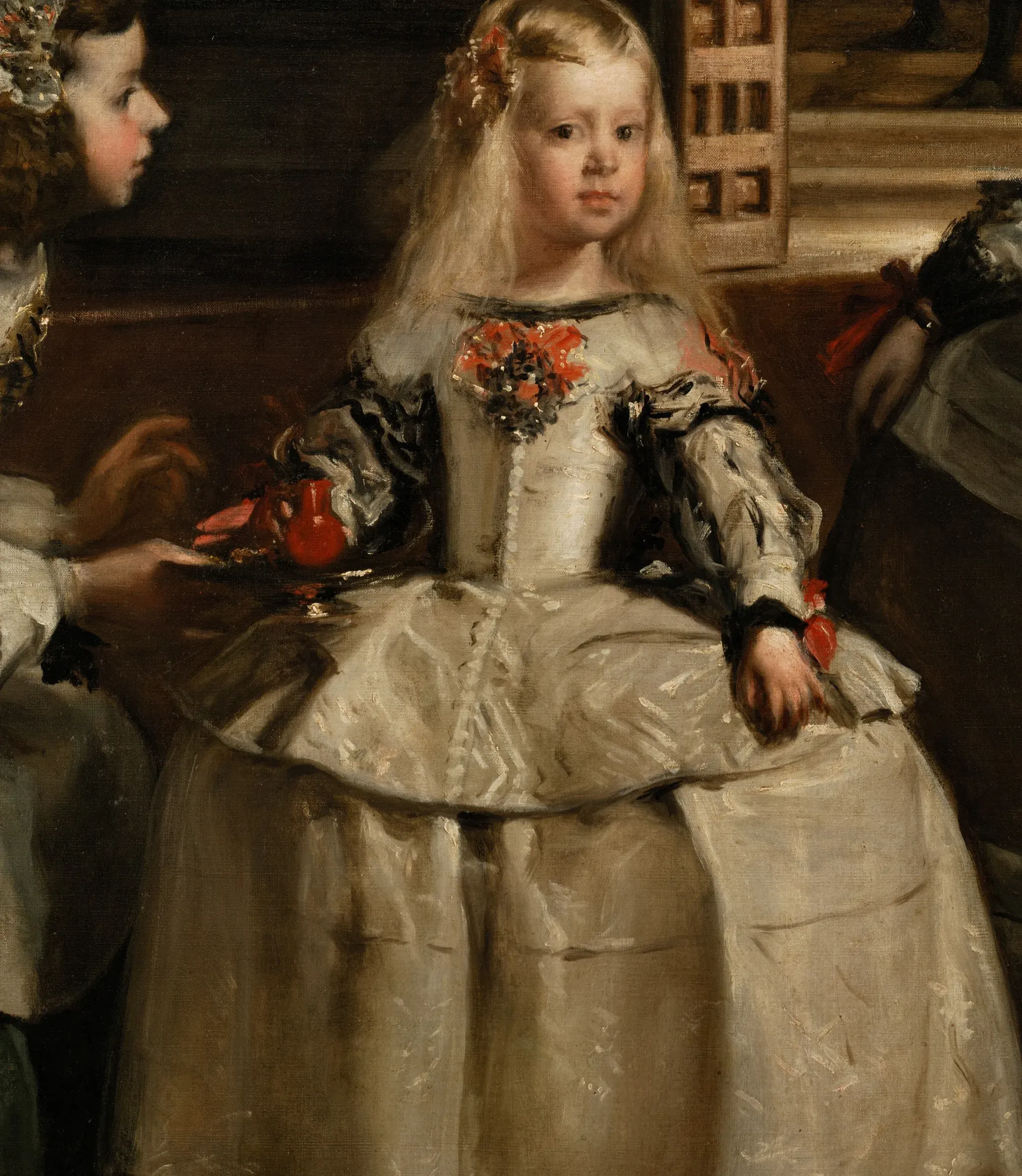 Detail of Las Meninas: the Infanta's pale gown carries the late economy in the open, a few loaded strokes of grey and cream dragged over the ground for the whole sheen of the satin, the red of the flask and the ribbons set in as the one warm accent.