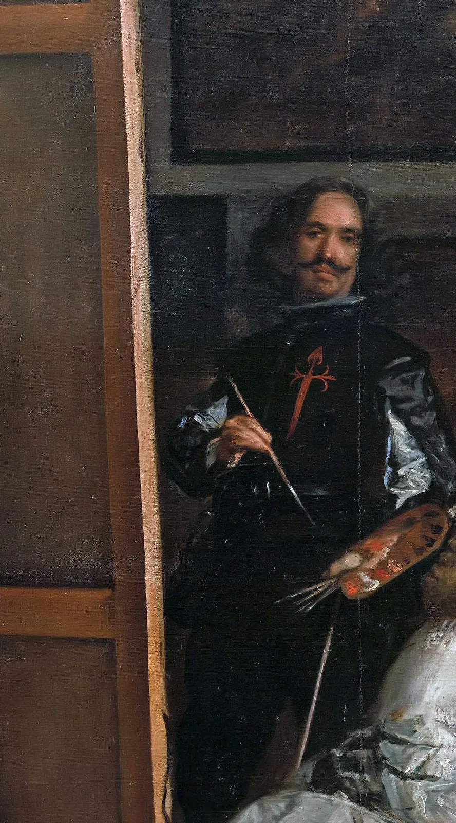 Detail of Las Meninas: he painted himself standing well back from the tall canvas, the brush raised in his right hand, a bundle of further long handles resting against the palette in the other. The length of the tool is what buys that working distance.
