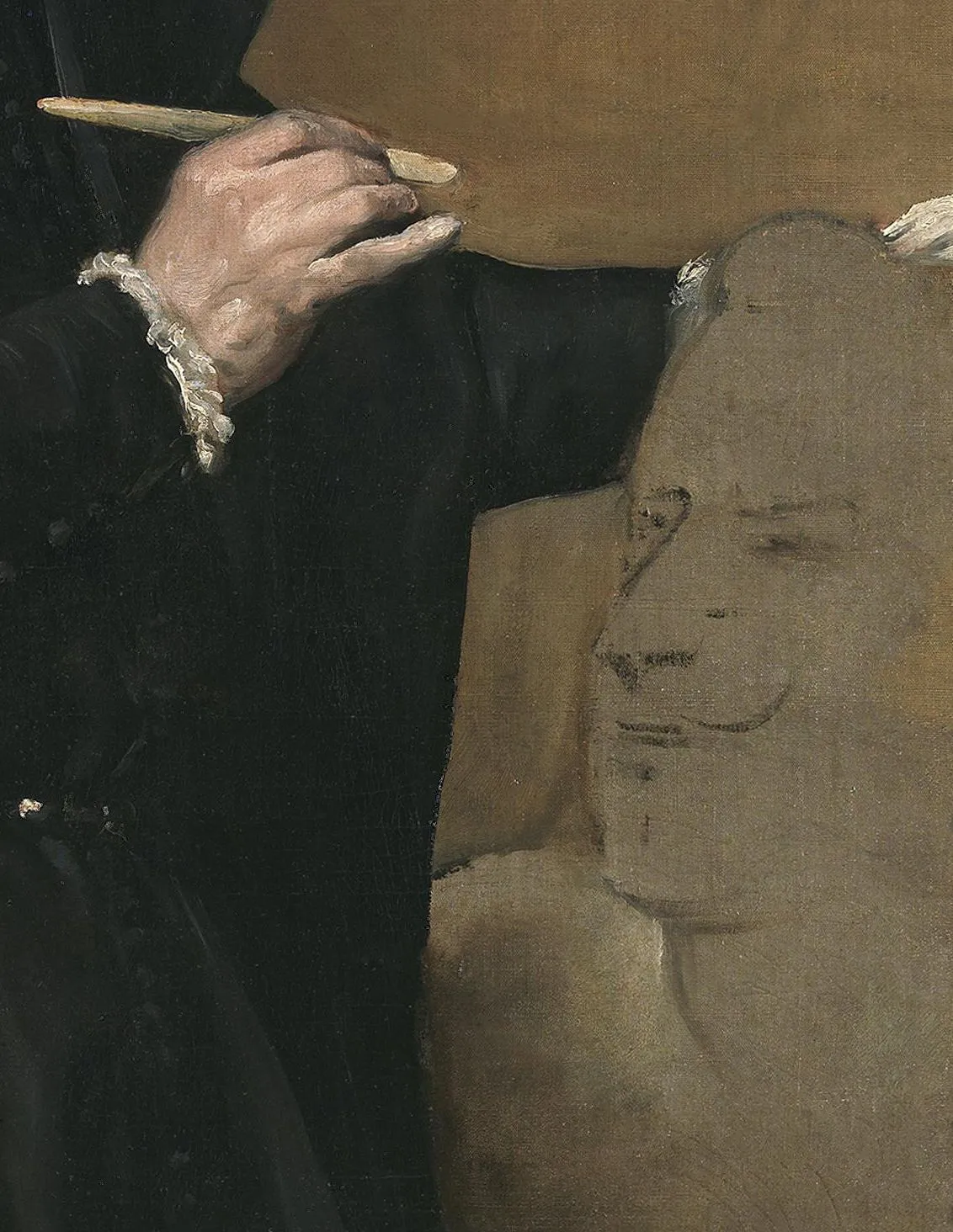 Detail of Juan Martínez Montañés: the clay head the sculptor is modelling is left at the lay-in stage, a thin pale mass with the features found in a few dark strokes straight on the surface, while the hand beside it is carried all the way to a finish. Both ends of the process sit in one canvas.