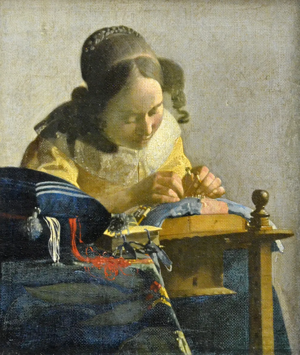The Lacemaker, twenty four by twenty one centimetres, the smallest picture he left. The red and white threads spilling from the cushion on the left are put down as loose paint with no drawing in them at all, while the hands and the pins a few centimetres behind are exact.