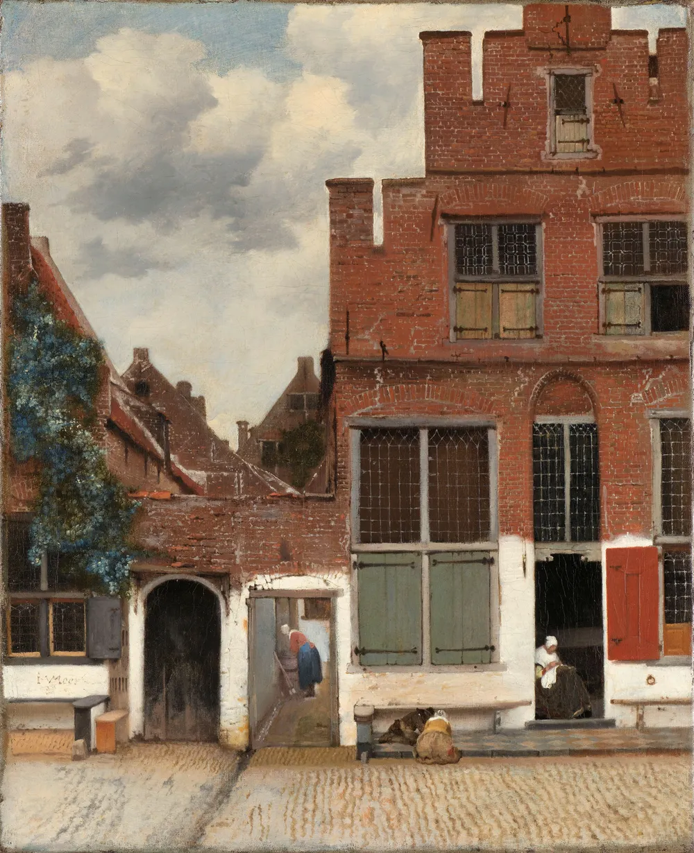 The Little Street, fifty four by forty four centimetres, the other outdoor picture. Frans Grijzenhout matched the house widths in the Delft quay dues register of 1667 to this pair of gateways and placed the spot at what is now Vlamingstraat 40 and 42, where an aunt of Vermeer's lived. Not every scholar accepts the identification.